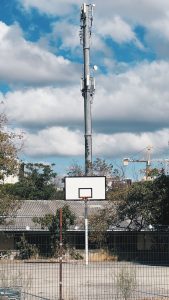 How to be more confident: attack the net. Outdoor basketball hoop on a concrete court.